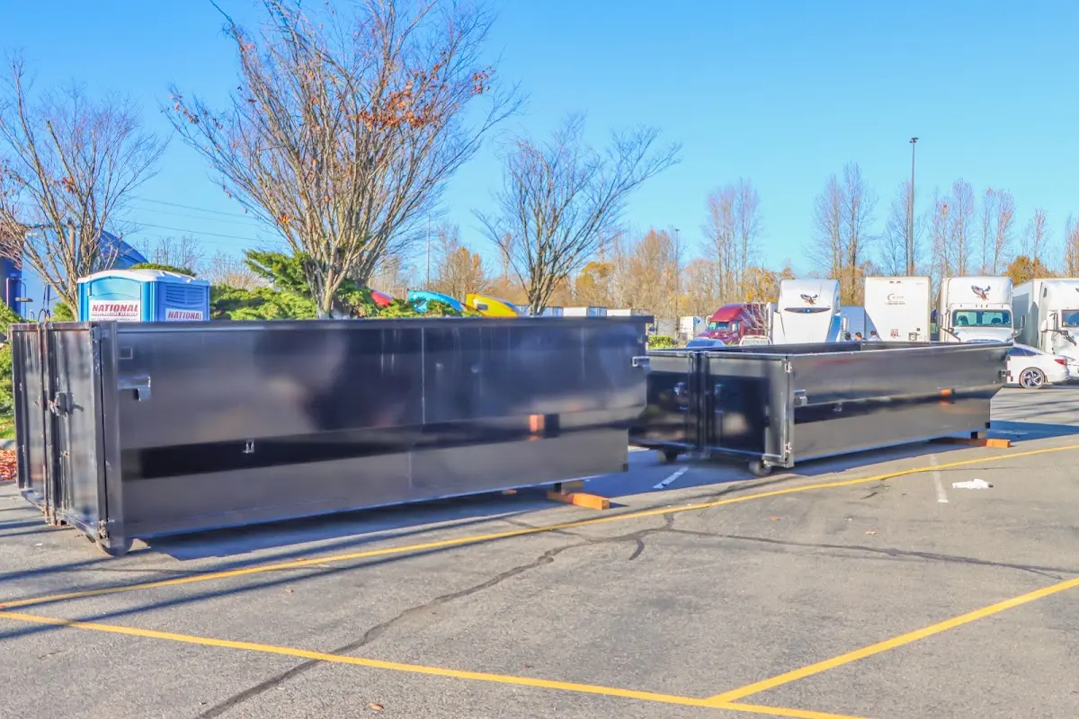 Professional dumpster rental service with roll-off container on residential driveway in Enumclaw